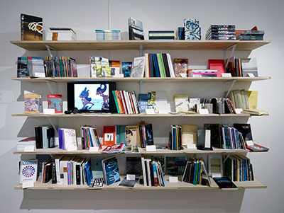  Bookshelf and still from video-poem by Stalina Villarreal, Antena @ Blaffer, Blaffer Art Museum, Houston Photography: Thomas DuBrock; Courtesy Blaffer Art Museum.