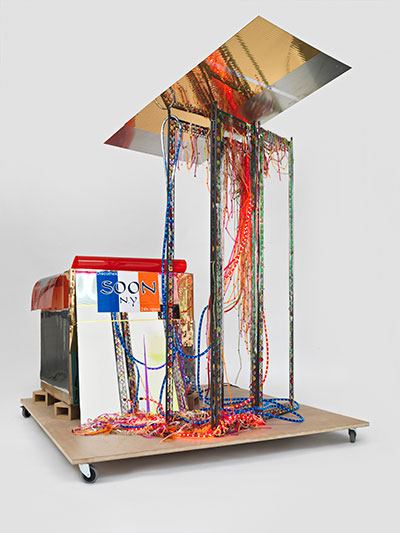 Disco Soon (Ground Zero), 2008 Isa Genzken Cardboard box, synthetic polymer paint on plastic, mirror, spray paint, metal, fabric, hose lights, mirror foil, printed sticker, wood blocks, fiberboard, and casters 86 1/4 x 80 11/16 x 64 15/16 " (219 x 205 x 165 cm) Carlos and Rosa de la Cruz Collection, Courtesy the artist and Galerie Buchholz, Cologne/Berlin © Isa Genzken
