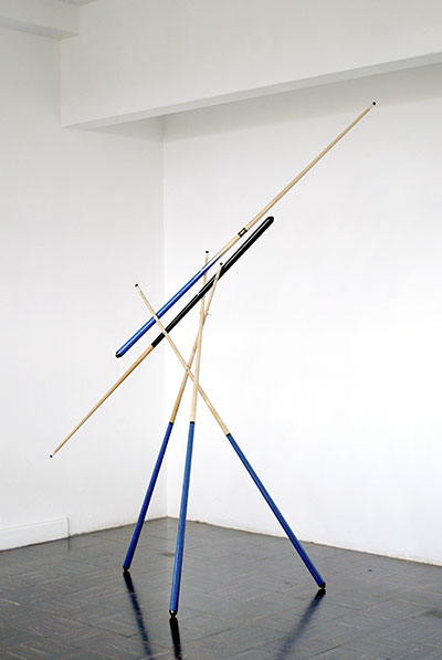 Darío Escobar, Juego a cinco manos (Five handed game), 2008. Wood, rubber, bronze, and plastic, 118 1/8 x 19 3/4 x 19 3/4 in.