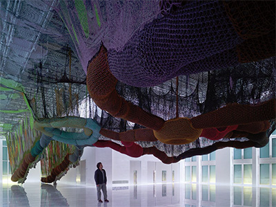 Ernesto Neto, O Bicho SusPenso na Paisagem, 2011, crochet, polypropylene balls, and stones. Installation view from HiperCultura Loucura en el Vertigo del Mundo at Los Molinos, Faena Art Center,… Buenos Aires, Argentina, 2011. Photo by Nikolas Koenig. Courtesy the artist; Tanya Bonakdar Gallery, New York; and Galeria Fortes Vilaça, São Paulo.