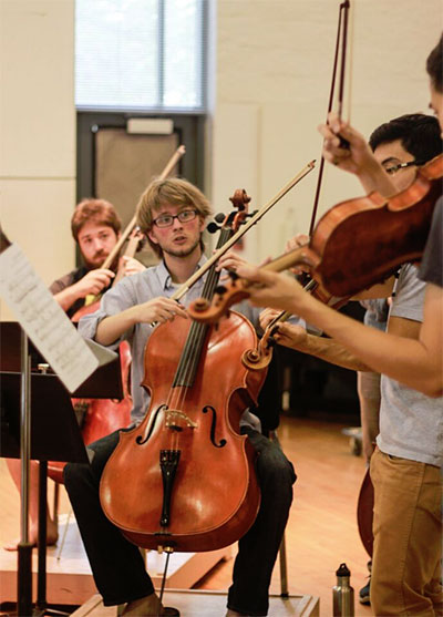 Cellists Max Geissler (foreground) and Nathan Watts (background), in rehearsal for KINETIC.