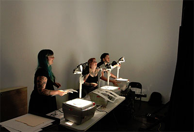 Lindsay Burleson, Jade Young and Mauricio Menjivar behind the scenes during Bootown’s White Raven, created and directed by Emily Hynds. Photo by Mark Wozny.