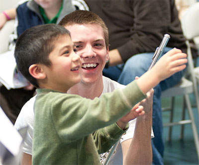 Garrett Hudson with a young WindSync fan. Photo by Nathan Simmons.