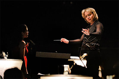 Anna Skryleva, a Russian conductor working primarily in Germany, conducts soprano Sarah Jane McMahon and The Dallas Opera Orchestra in “Things Change, Jo” from Mark Adamo’s opera Little Women. Photo by Karen Almond, Dallas Opera.