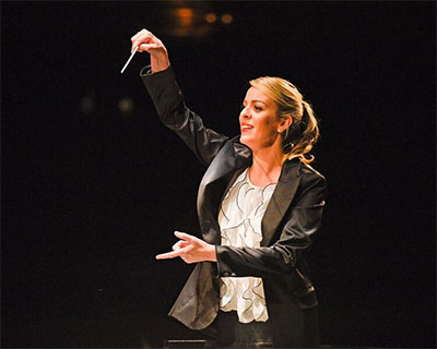 Australian conductor Jessica Gethin leads The Dallas Opera Orchestra during the Inaugural Institute Concert last December. Photo by Karen Almond, Dallas Opera.