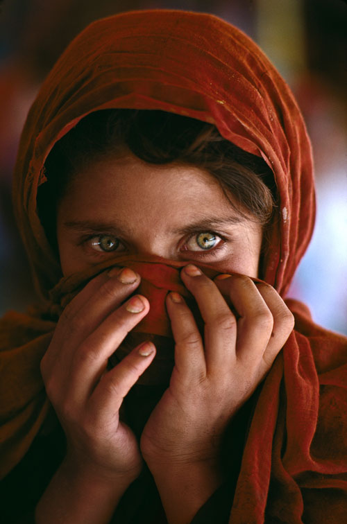 "Afghan Girl Hiding Face" by Steve McCurry