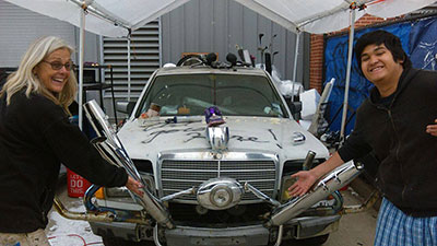 Rebecca Bass and a Reagan High School student work on their entry for the 2015 Houston Art Car Parade. Photo by Rebecca Bass