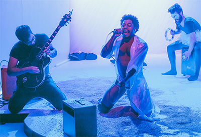 Gerardo Velasquez, Orlanders Jones and Dano Colon in the Rec Room production of Dead Rockstar Sing-A-Long Club. Photo by Chloe Gonzalez.