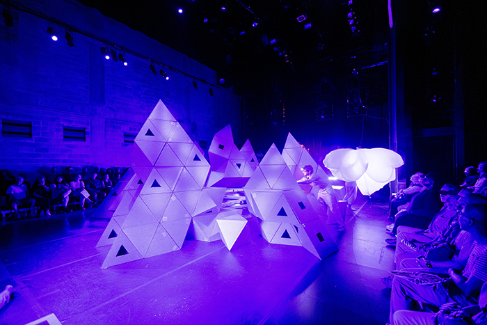 Not Every Mountain by Rude Mechs, with geometric mountain forms under blue stage lighting at Fusebox 2026.